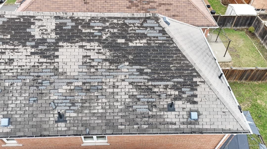 Aerial roof photo showing shingle wear, granule loss and curling edges